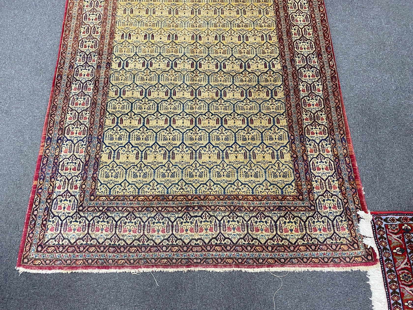 An antique North West Persian faded peach ground rug, 200 x 148cm